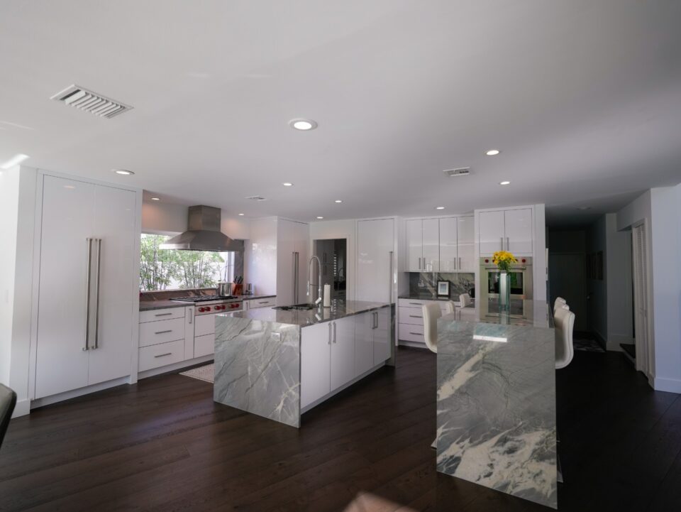 glossy white double island kitchen