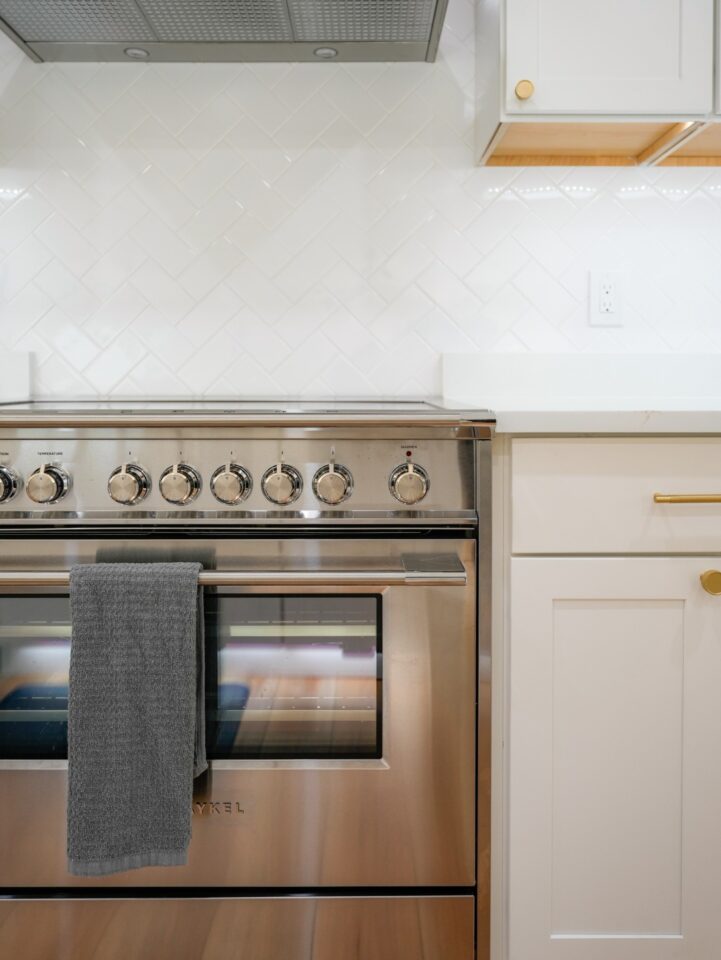stainless range white herringbone backsplash