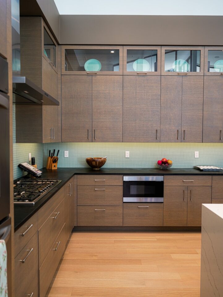 walnut cabinetry green mosaic backsplash